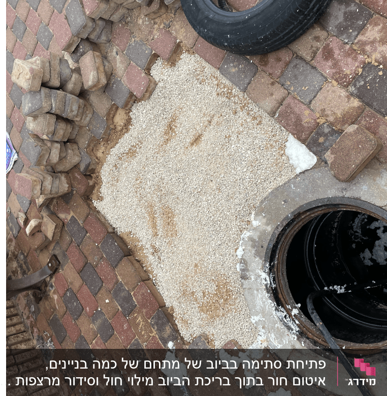 פתח ביוב עם צינור, לבנים וחצץ מסביב